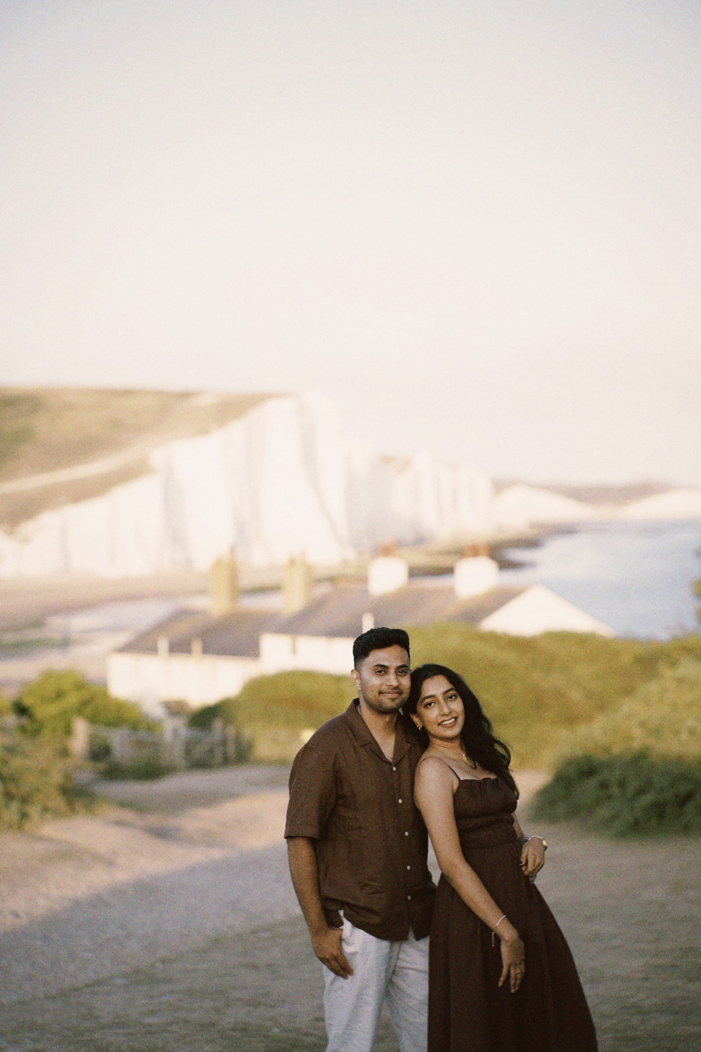 Arun and Anaina smiling together with the chalk cliffs behind them